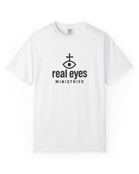 White t-shirt with 'real eyes ministries' logo on a white background