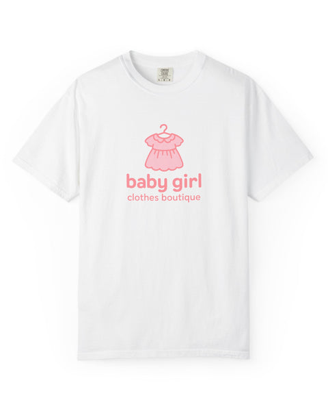 White t-shirt with pink baby dress graphic and 'baby girl clothes boutique' text on a white background