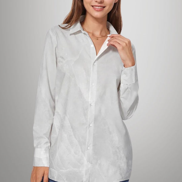 Woman wearing a white button-up shirt against a plain background
