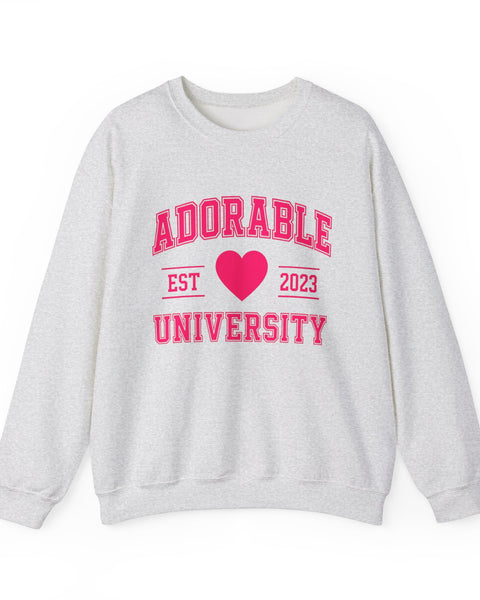 Grey crewneck sweatshirt with 'ADORABLE UNIVERSITY EST 2023' printed in pink on the front.