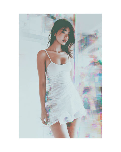 Asian woman wearing a white slip dress with a colorful abstract glitched background