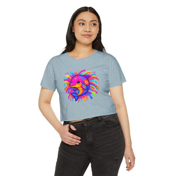 Woman wearing a light blue t-shirt with a colorful dolphin design on a white background