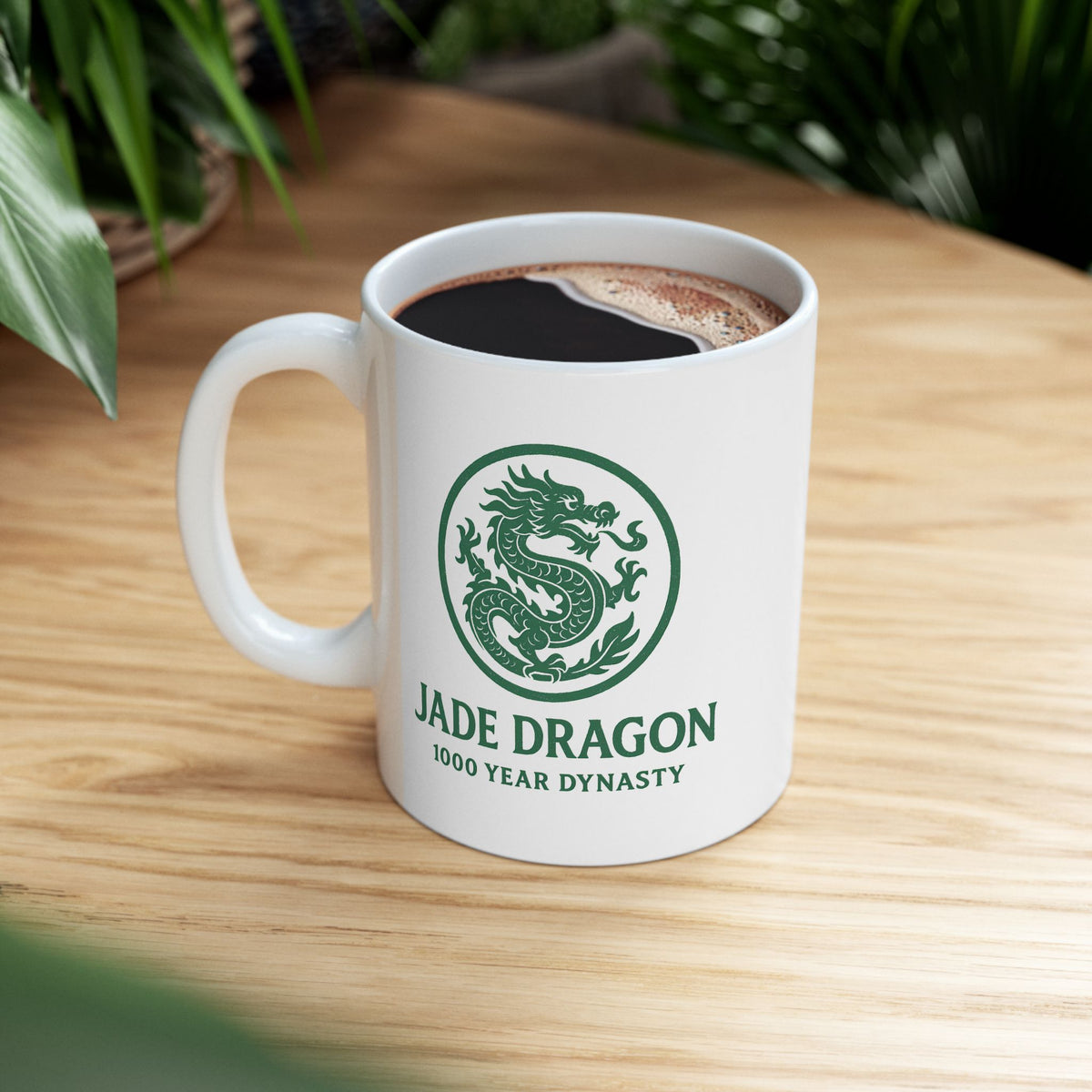 White mug with 'Jade Dragon' logo on a wooden table