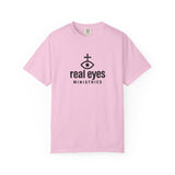 Pink t-shirt with 'real eyes ministries' logo on a white background