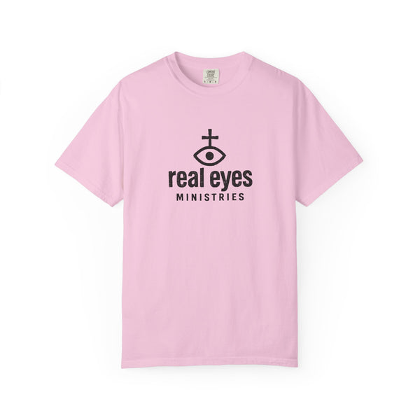 Pink t-shirt with 'real eyes ministries' logo on a white background