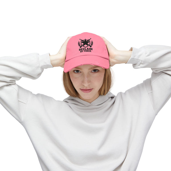 Person wearing a pink cap with a logo and text, posing against a white background