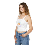 Woman wearing a white tank top with colorful text and blue jeans on a white background
