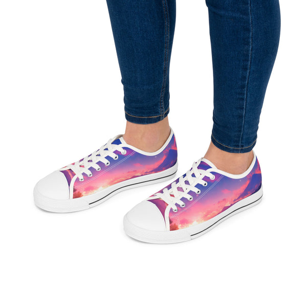 Sneakers with a colorful sunset gradient design worn with blue jeans on a white background