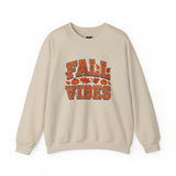 Beige sweatshirt with 'Fall Vibes' text and autumn-themed graphics on a white background