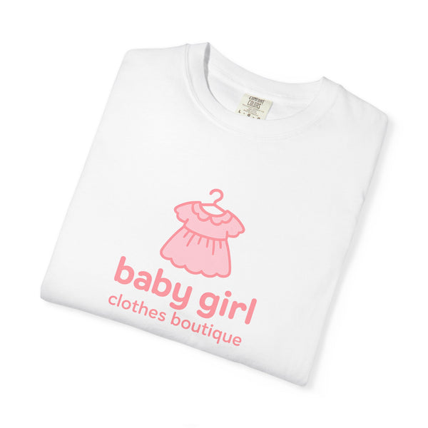 White t-shirt with pink dress graphic and 'baby girl clothes boutique' text on a white background