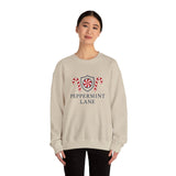 Person wearing a beige sweatshirt with 'Peppermint Lane' design on a white background
