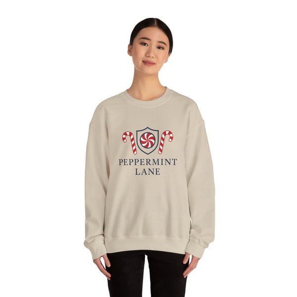 Person wearing a beige sweatshirt with 'Peppermint Lane' design on a white background