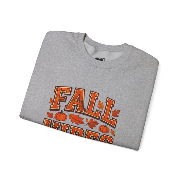 Folded gray sweatshirt with 'Fall Vibes' text and pumpkins on a white background
