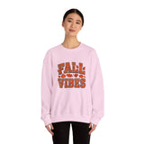 Person wearing a pink sweatshirt with 'Fall Vibes' text on a white background