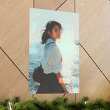 large poster of a japanese schoolgirl smiling with a sparkling sea background placed on geometric wall