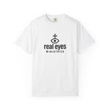 White t-shirt with 'real eyes ministries' logo on a white background