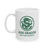 White mug with green dragon design and text on a white background