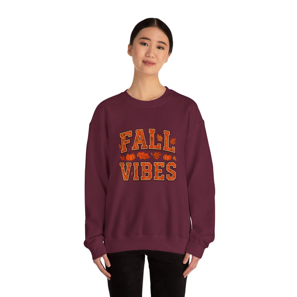 Maroon sweatshirt with 'Fall Vibes' text worn by an asian woman on a white background