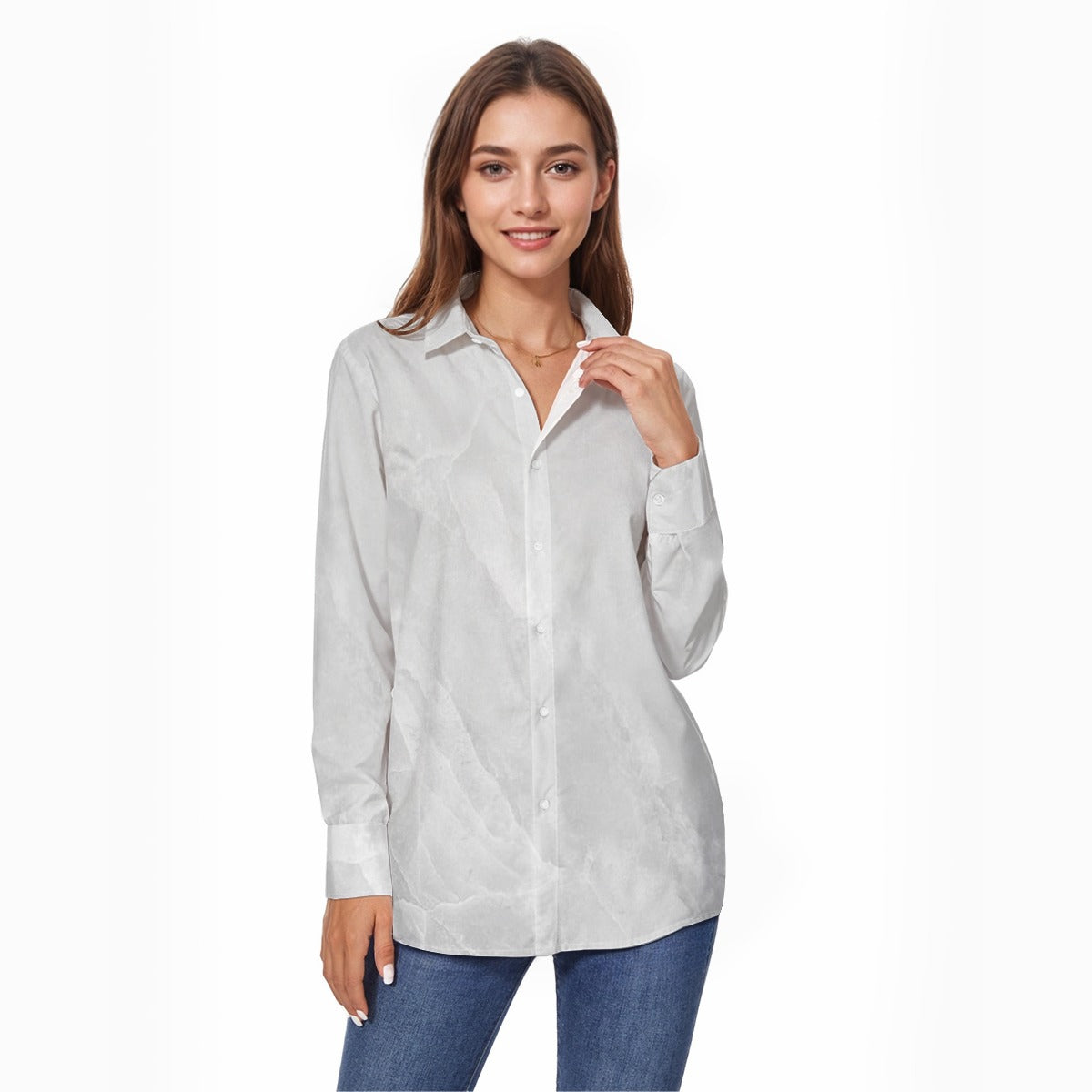 Woman wearing a light gray button-up shirt and blue jeans on a white background