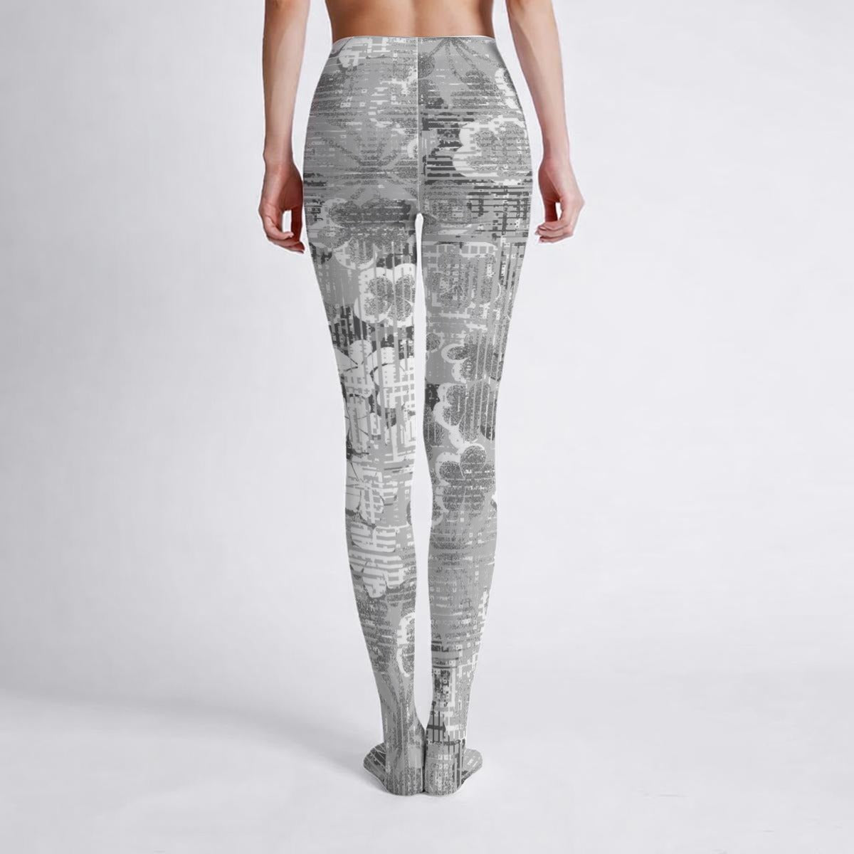 woman wearing gray patterned flower leggings on a white background