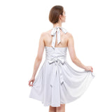 Woman wearing a white halter neck dress with bow details on a white background