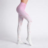 White and pink anime tights with pink floral pattern worn by a woman on a light gray background