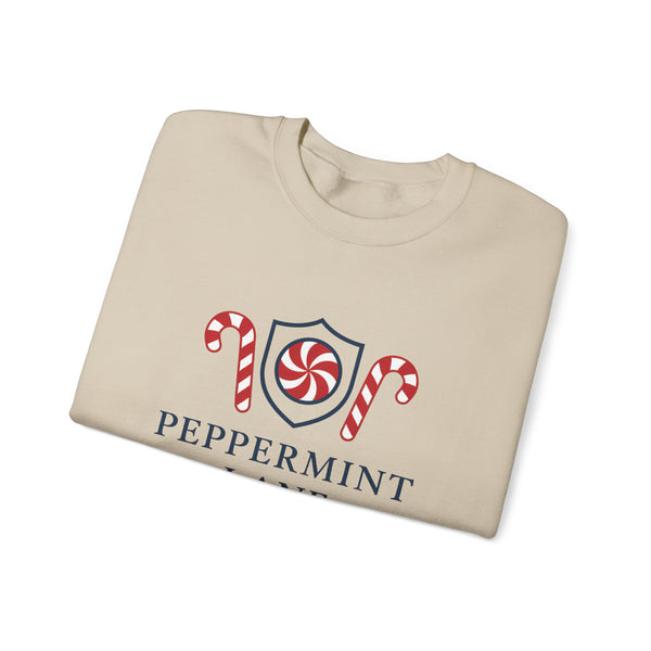 Folded beige sweatshirt with peppermint-themed design on a white background