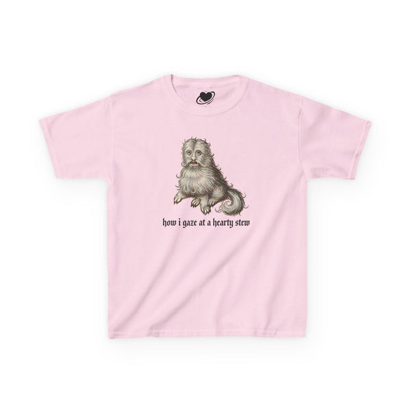 A light pink baby tee featuring a vintage-style illustration of a medieval dog meme and the text 'how i gaze at a hearty stew' printed on the front.