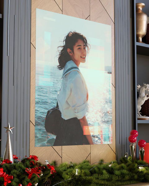large poster of a japanese schoolgirl smiling with a sparkling sea background placed on geometric wall