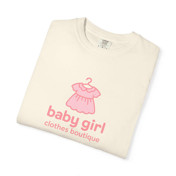 Folded cream-colored sweatshirt with pink dress graphic and 'baby girl clothes boutique' text on a white background