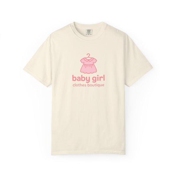 Beige t-shirt with pink baby dress graphic and 'baby girl clothes boutique' text on a white background