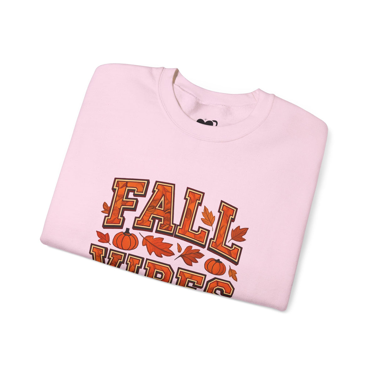 Folded pink sweatshirt with 'Fall Vibes' text and autumn graphics on a white background