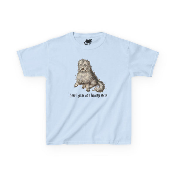 A light blue baby tee featuring a vintage-style illustration of a medieval dog meme and the text 'how i gaze at a hearty stew' printed on the front.
