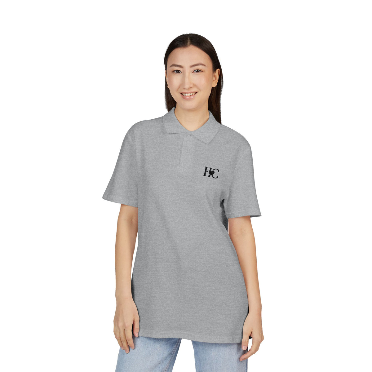 Person wearing a gray Heart Circle polo shirt with a logo on a white background