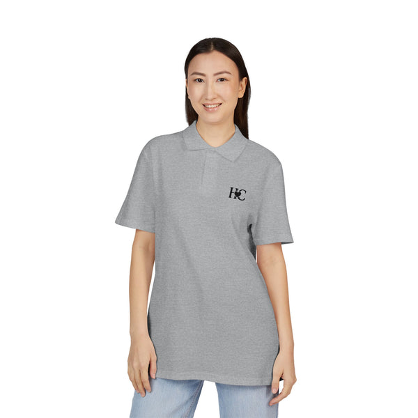 Person wearing a gray Heart Circle polo shirt with a logo on a white background