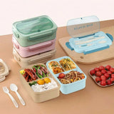 Set of colorful bento boxes with food compartments on a wooden surface.