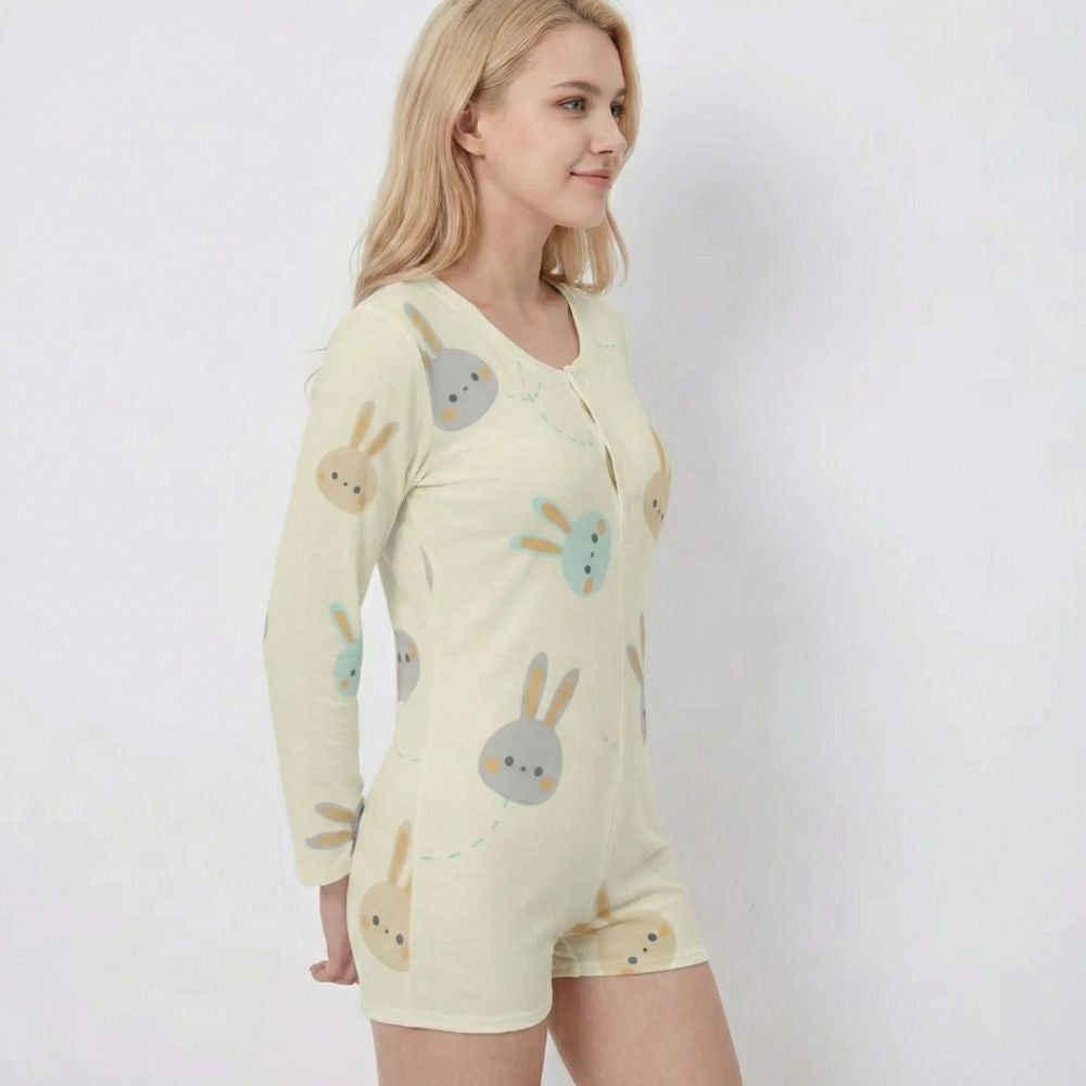 Woman wearing a light yellow pajama set with cartoon bunny patterns on a white background