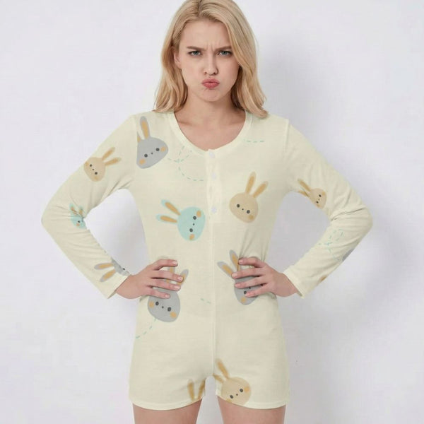 Woman wearing a light yellow romper with bunny designs on a plain background