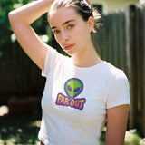 Woman wearing a white t-shirt with an alien graphic and 'FAR OUT' text outdoors.