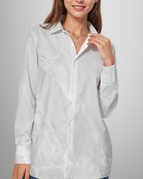 Woman wearing a white button-up shirt against a plain background