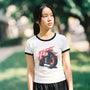 Asian girl wearing a vintage anime t-shirt with a motorcycle graphic outdoors