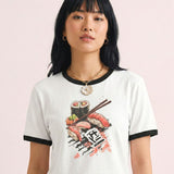 Woman wearing a vintage white t-shirt with sushi graphic on a pink background